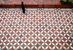 The lower platform with red sand stone and marble design at the Taj Mahal in Agra. The Taj Mahal has many interesting patterns used in the flooring in its exterior as well as in the interior of its buildings.